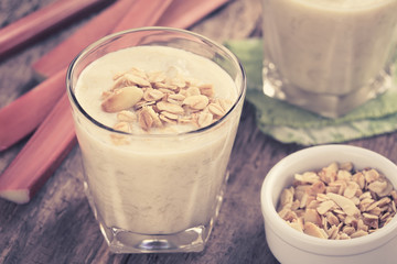 Refreshing rhubarb and yogurt smoothie topped with homemade oatmeal almond granola (Selective Focus in middle of granola on drink) (Digitally Altered: Toned Image)