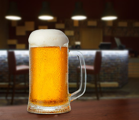cold light beer glass mug in a pub