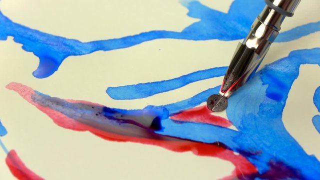 Slow-mo footage. Artist girl hand draws a pen with red ink. close-up