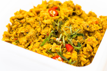 Cost-up Thai food menu is Stir Fried Minced Chicken Breast with Hot Yellow Curry Paste Served with Rice and Fried Egg box set isolated on white background. It copy space and selection focus.