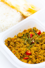 Cost-up Thai food menu is Stir Fried Minced Chicken Breast with Hot Yellow Curry Paste Served with Rice and Fried Egg box set isolated on white background. It copy space and selection focus.