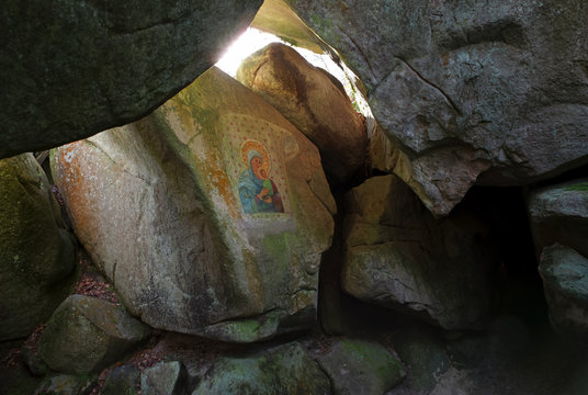 Virgin Mary painted on rock in Fontainebleau forest grotto