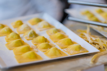 Making fresh ravioli and traditional pasta in a kitchen
