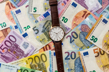Clock on euro banknotes. close up .
