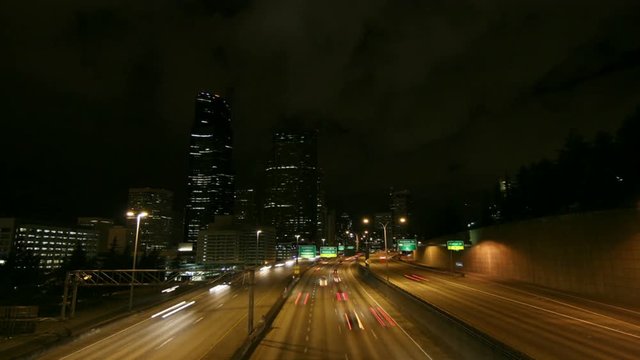 A beautiful shot of time lapsed freeway traffic in a downtown area.