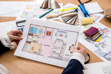 Fototapeta na wymiar nterior designerwith color swatch and building plans on office