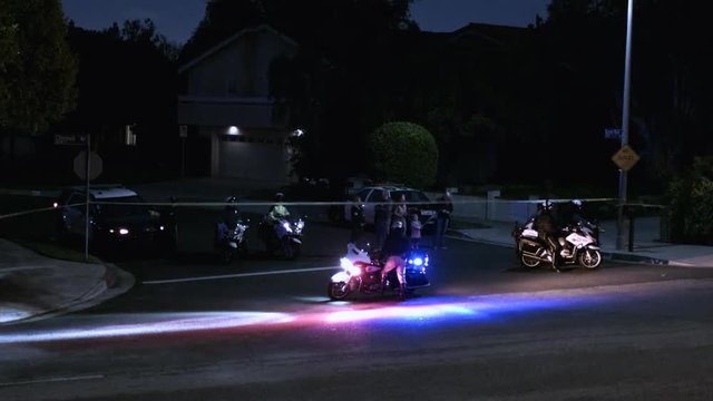 Police Block A Road In An Urban Neighborhood At Night.