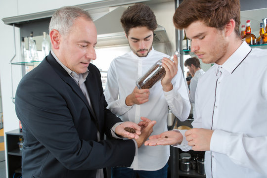 boy apprentices smeling aroma arabica coffee beans