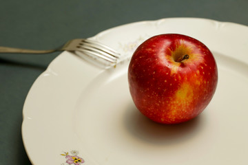 Close up image of red apple on the plate