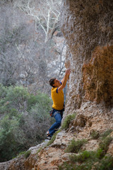 Obraz premium rock-climber climbs route with lower insurance 