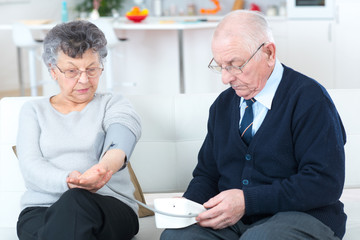 woman controlling blood pressure of husband