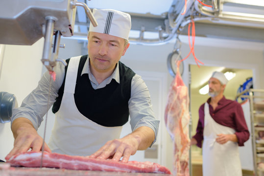 butcher cuts meat