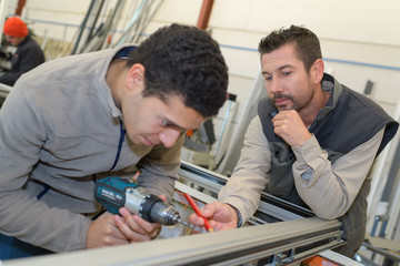 man drills frame window