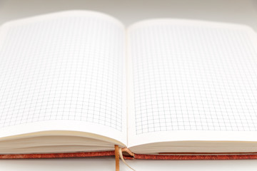 Open blank notepad on white background close-up