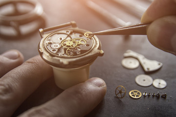 Watchmaker is repairing the mechanical watches in his workshop