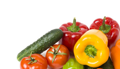 Red yellow and orange peppers with tomatoes on a white background. Cucumbers with colorful peppers in composition on a white background.