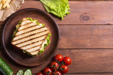 Club sandwich with tomatoes , cucumber , ham and cheese