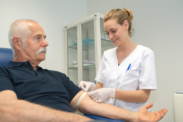 nurse preparing patient for a blood test