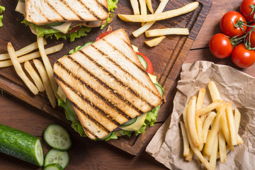 Club sandwich with tomatoes , cucumber , ham and cheese
