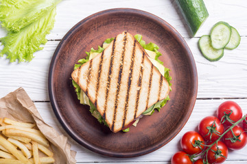 Club sandwich with tomatoes , cucumber , ham and cheese