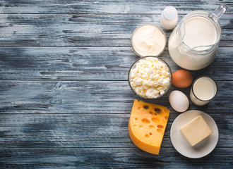 Dairy products grocery assortment on rustic wooden table. Top view.