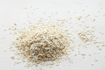 heap of rolled oats on a white background