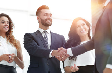 handshake business partners at a meeting
