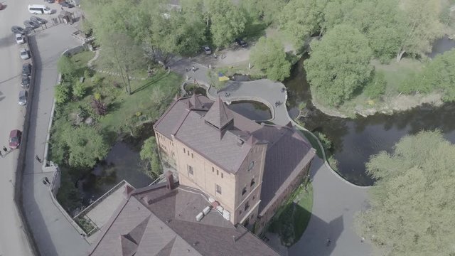 Aerial view of Historical and cultural complex Castle-museum Radomysl- the museum of Ukrainian home icons. Flying around the Radomyshlsky Castle with a view of the surrounding landscapes of the lake