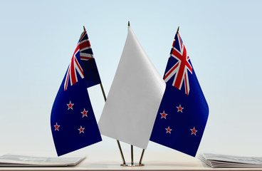 Two flags of New Zealand with a white flag in the middle