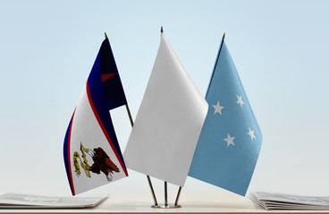 Flags of American Samoa and Federated States of Micronesia with a white flag in the middle