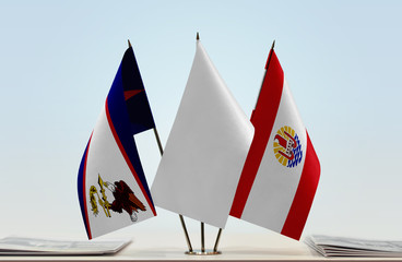 Flags of American Samoa and French Polynesia with a white flag in the middle