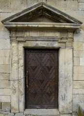 Fototapeta na wymiar Ancient door in a castle. Old wooden door.
