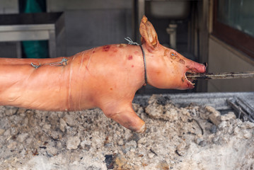 Grilled whole pig on a skewer. Traditional Greek food.