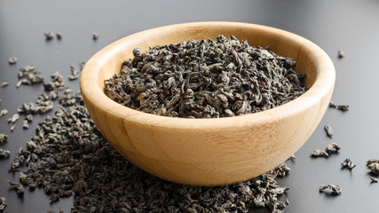 black tea leaves in a wooden bowl