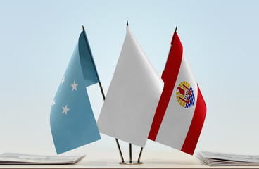 Flags of Federated States of Micronesia and French Polynesia with a white flag in the middle