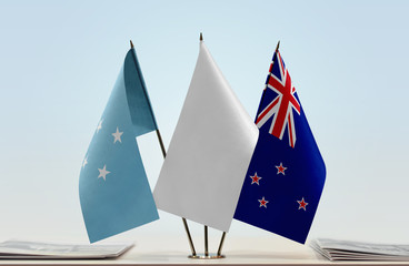 Flags of Federated States of Micronesia and New Zealand with a white flag in the middle