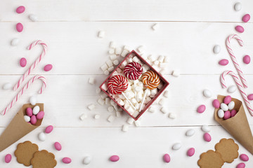 Frame Candies, cookies,Marshmallows and Lollipops Gift Top view White wooden Background