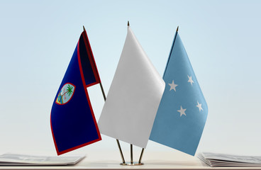 Flags of Guam and Federated States of Micronesia with a white flag in the middle