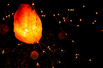 Himalayan salt lamp and garland on table