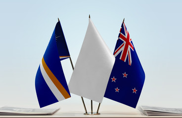 Flags of Marshall Islands and New Zealand with a white flag in the middle