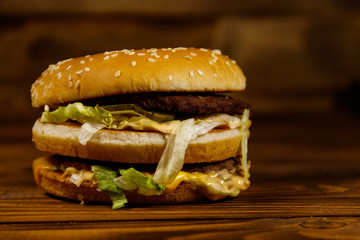 Delicious big hamburger on wooden table