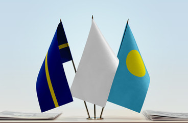 Flags of Nauru and Palau with a white flag in the middle