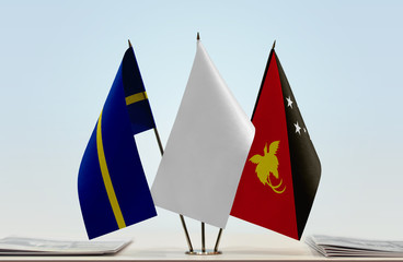 Flags of Nauru and Papua New Guinea with a white flag in the middle