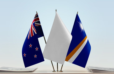 Flags of New Zealand and Marshall Islands with a white flag in the middle