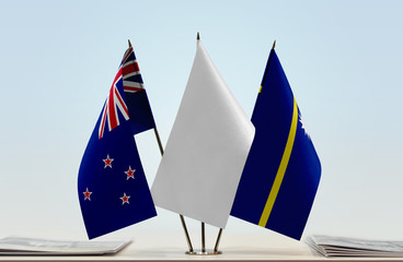 Flags of New Zealand and Nauru with a white flag in the middle
