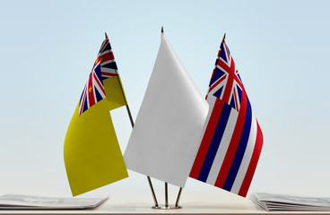 Flags of Niue and Hawaii with a white flag in the middle