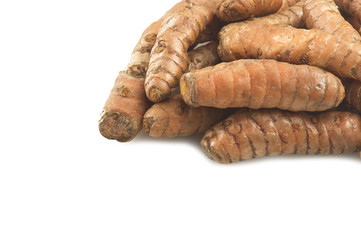 turmeric root and some slices on a white background