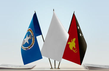 Flags of Northern Mariana Islands and Papua New Guinea with a white flag in the middle
