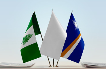 Flags of Norfolk Island and Marshall Islands with a white flag in the middle