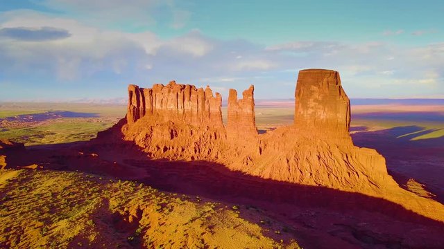 Beautiful inspiring aerial at sunset over rock formations in Monument Valley, Utah.